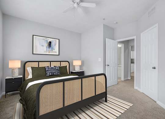 A bedroom with a bed, nightstands, and a painting on the wall.