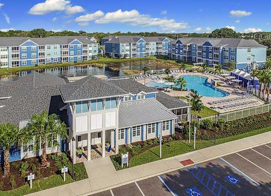 A large building with a pool in front of it.