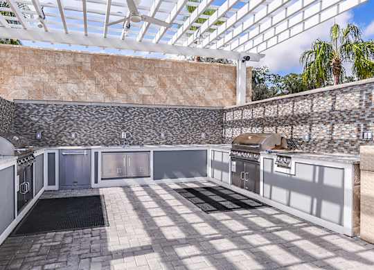 A kitchen with a glass roof and stone walls.