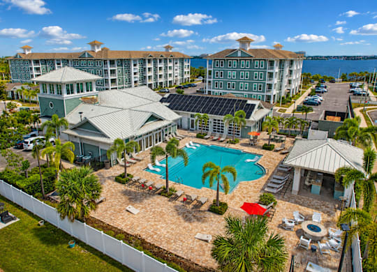 A resort with a pool and palm trees.