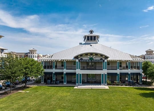 a building with a lawn and trees in front of it