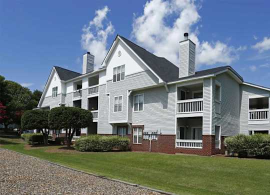 A large house with a grey exterior and a balcony.