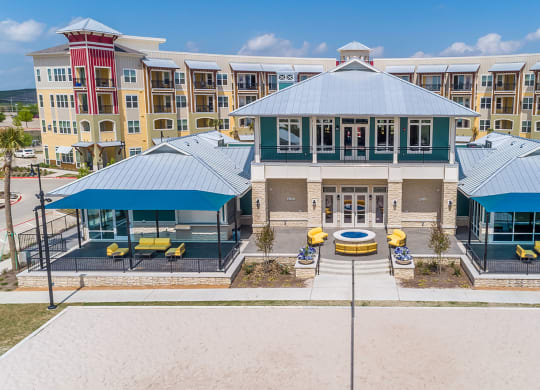 Apartments for Rent in Lewisville TX - Hebron 121 Station - Relaxing Fire Pit with Comfortable Seating, Clubhouse, and Umbrellas