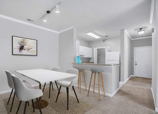A white dining table with four chairs and a kitchen area in the background.