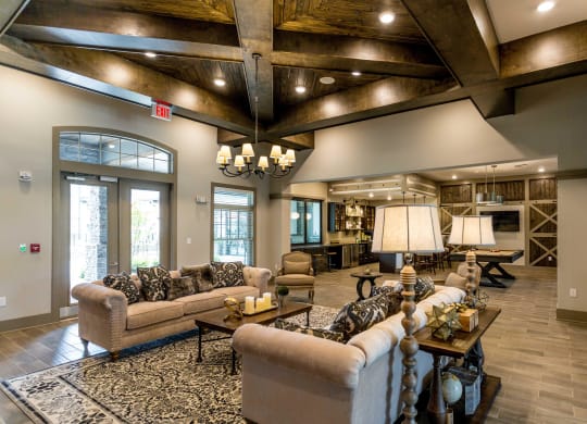 a large living room with couches and chairs and a fireplace
