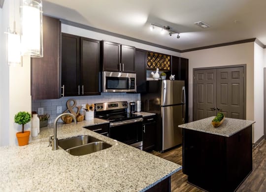 a kitchen with stainless steel appliances and granite counter tops