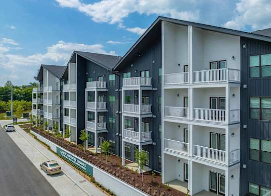 an exterior view of an apartment building on a city street
