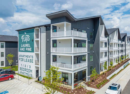 an apartment building with cars parked in front of it