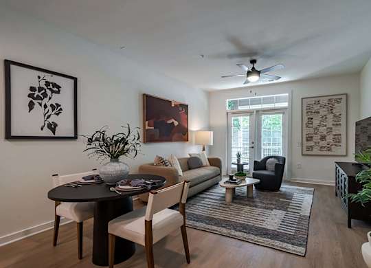 A living room with a dining table and chairs.