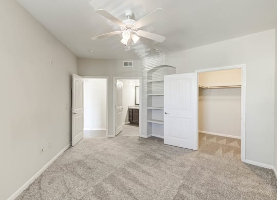 Three Bedroom Apartments in Lewisville TX - Hebron 121 Station - Cozy Bedroom with Carpeted Flooring, Built-In Shelves, and Large Closet