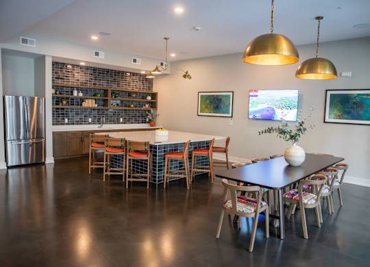 A modern kitchen with a dining table and chairs.
