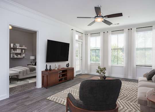 A living room with a black chair in the center.
