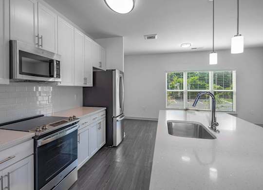 a kitchen with white cabinets and a sink