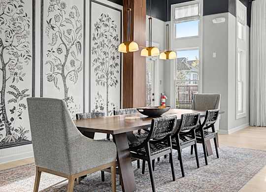 A dining room with a table and chairs.
