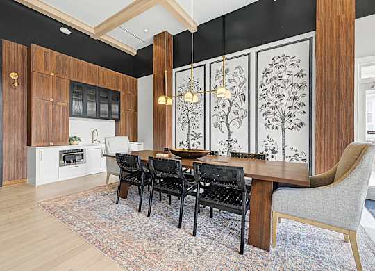 A dining room with a table set for four.