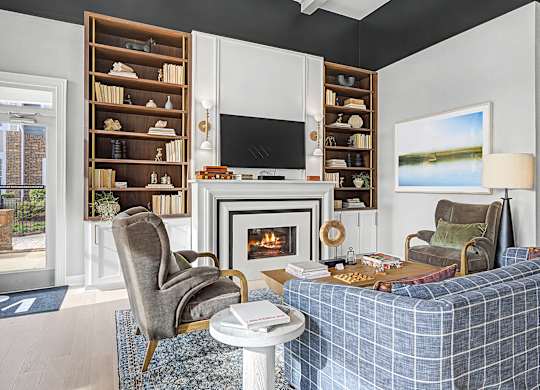 A living room with a fireplace and a blue couch.