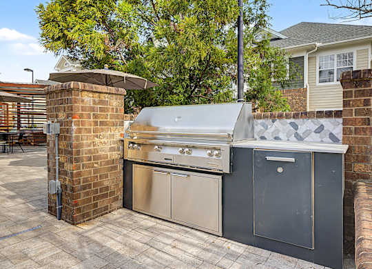 A stainless steel oven and dishwasher are installed on a patio.
