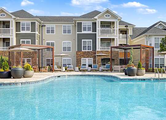A swimming pool in front of apartment buildings.