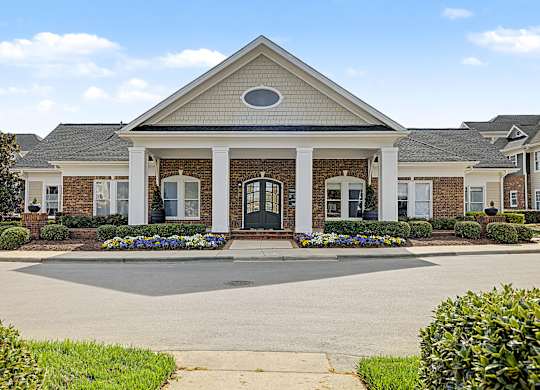 A building with a front yard and a driveway.
