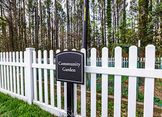 A sign that says Community Garden is mounted on a post.