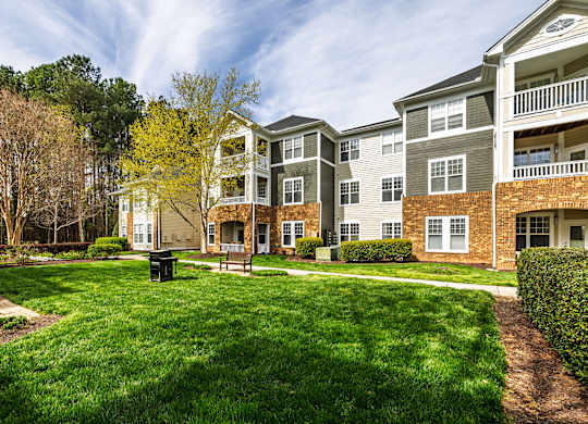 Apartment complex with a green lawn in front.