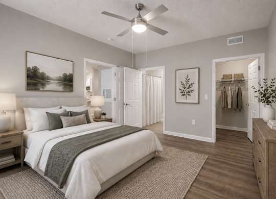 A bedroom with a large bed, a dresser, and a mirror.