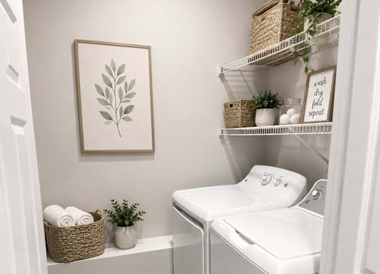 A small laundry room with a washer and dryer.