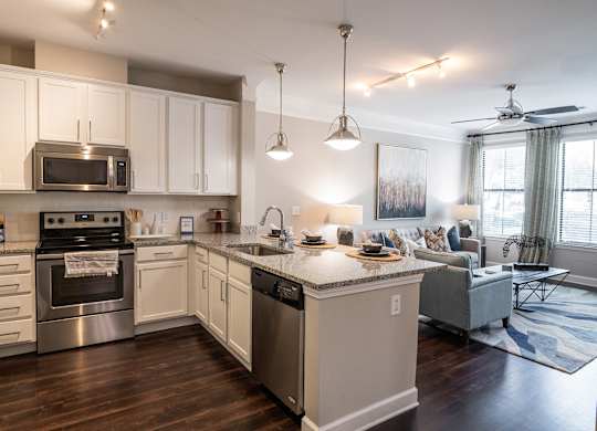 A modern kitchen with a large island and a dining area.