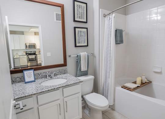 A bathroom with a toilet, sink, and bathtub.