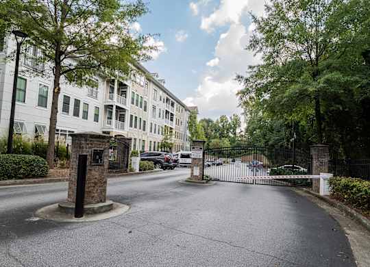 A street view of a gated entrance to a residential building.