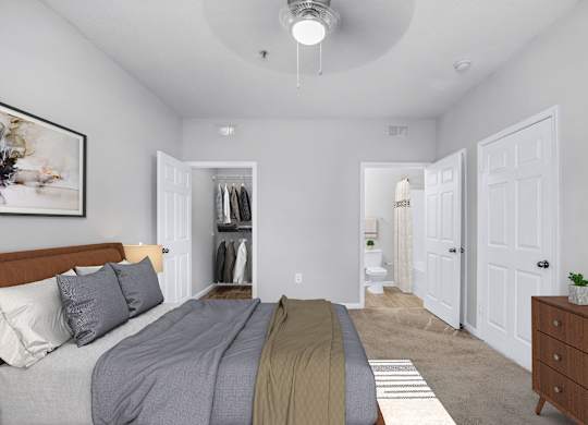A bedroom with a bed, dresser, and a painting on the wall.
