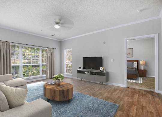 A living room with a television, a couch, and a coffee table.