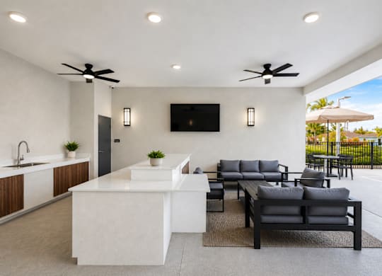 A modern outdoor living space with a kitchen area.
