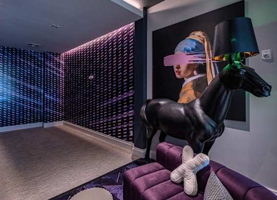 a living room with a horse statue and a purple couch at Altis Grand Lake Willis, Orlando, FL 32821