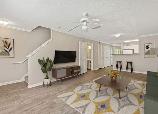 A living room with a staircase and a television.
