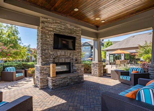 the preserve at ballantyne commons covered patio with fireplace and seating