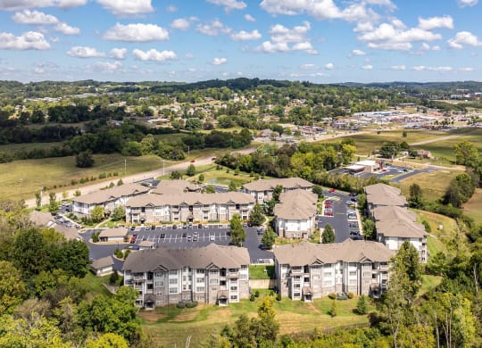 an aerial view of an apartment complex with a city in the background