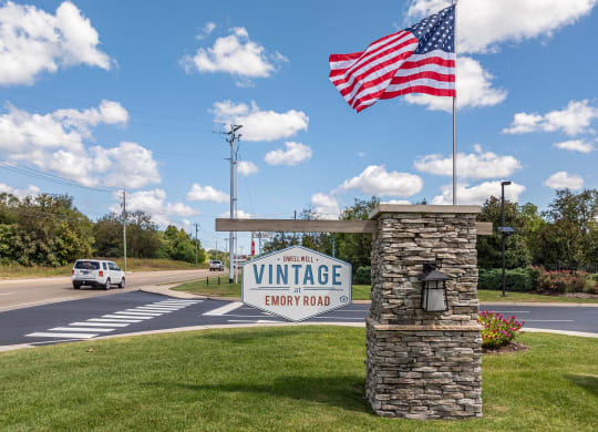 an flag flying over the entrance to a winery sign