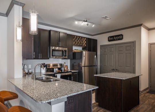 a kitchen with granite counter tops and stainless steel appliances