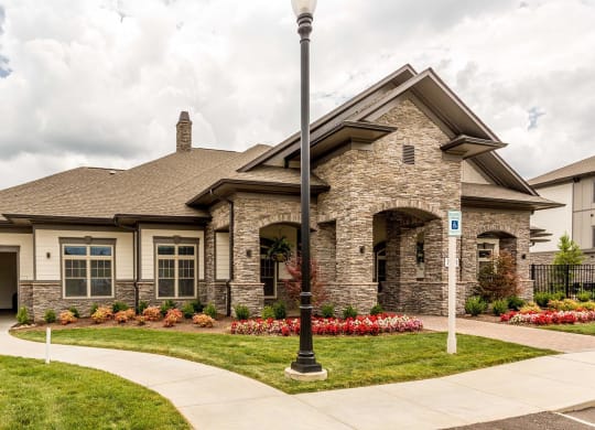the front of a house with a sidewalk in front of it