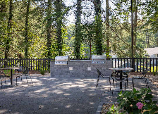 A backyard with a grill and seating area.