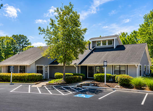 A building with a parking lot in front of it.