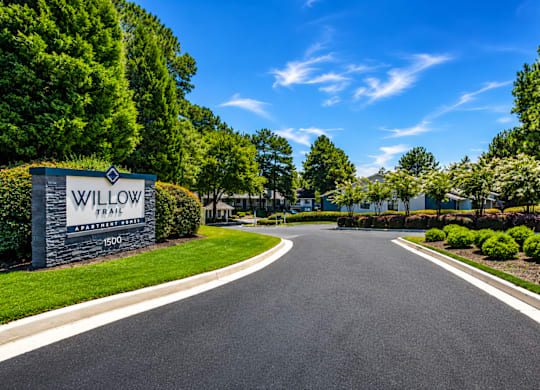 A road leading to a sign that says Willow.