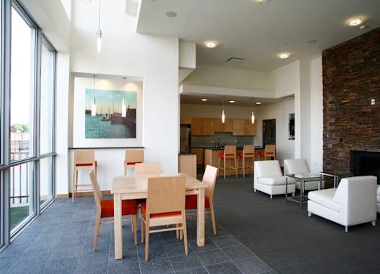 A dining room with a table and chairs.