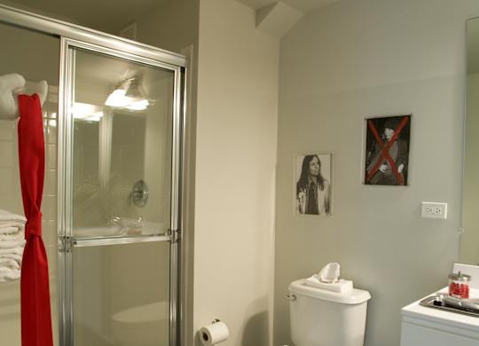 A bathroom with a toilet, a sink, and a shower.