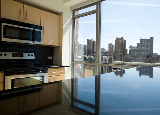 A kitchen with a view of the city.