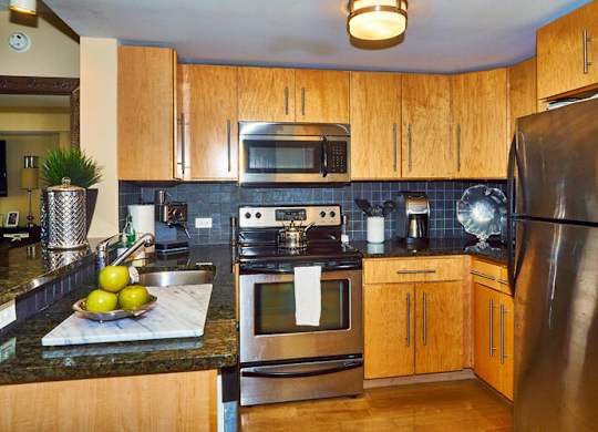 66 Main - Kitchen w/ Granite Counter and Backsplash