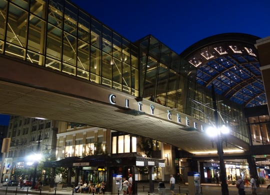 a view of the exterior of the city center mall at night