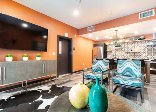 a living room with orange walls and a black and white rug