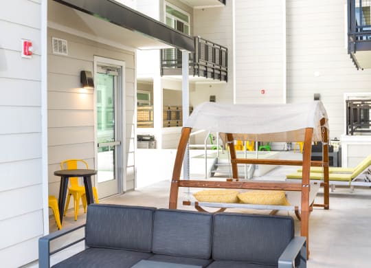 a couch and a bed in front of an apartment building